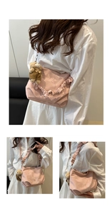 Detail of pink ruffled shoulder bag featuring soft fabric and a cute bear pendant charm