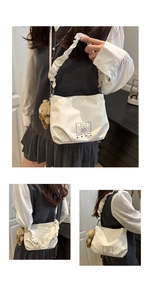 White crossbody bag with ruched shoulder strap and cute teddy bear plush charm