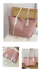 Detail of light pink tote bag with beige straps and lychee texture in home setting