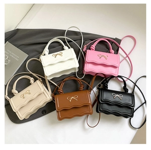 Collection of PU leather small square bags with wavy flaps and gold bow details
