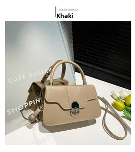Detailed close-up of khaki satchel bag featuring a silver twist lock and smooth texture