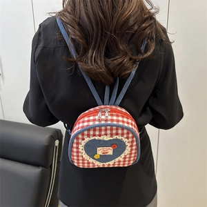 Mini red plaid backpack with denim heart embroidery and cherry detail shown on model