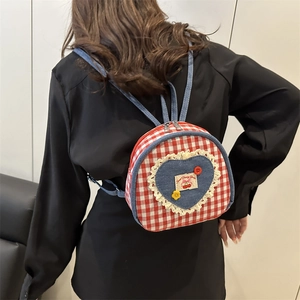 Mini red and white plaid backpack with denim heart patch and lace detail on model