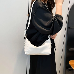 Minimalist white hobo shoulder bag with silver hardware on model, french retro style