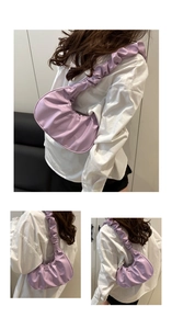 Detail shot of purple pleated cloud bag showing crescent shape and gathered strap