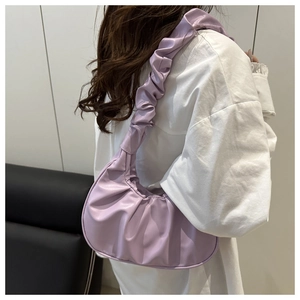 Detail of lavender pleated underarm bag showing soft cloud-like texture on model
