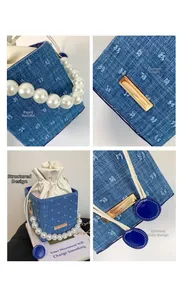 Detail of blue denim cube bag with pearl handle, contrast stitching and drawstring closure