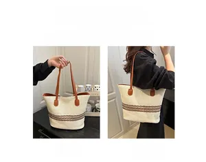 Detail of woven tote bag with floral accents showing handheld and shoulder carrying styles