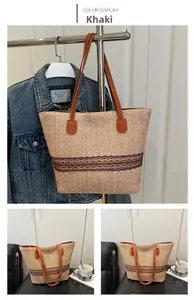 Detail of khaki hand-woven tote bag with brown lace trim and leather shoulder strap
