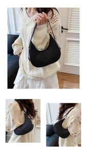 Detail shot of black sequin hobo bag showing sparkling texture and gold zipper accents