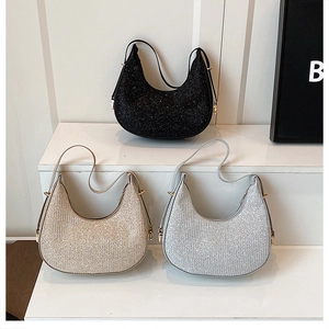 Three crescent hobo bags in black, champagne gold, and silver with glitter finish