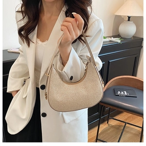 Detail of champagne gold hobo bag with shimmering texture and elegant metallic finish