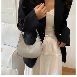 Silver crescent hobo bag with sparkling sequin texture and metallic buckle detail
