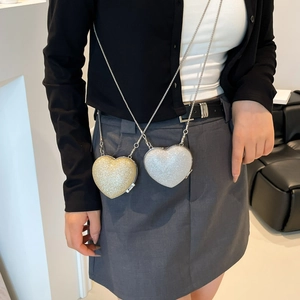 Mini heart-shaped sequined crossbody bag with metallic chain straps in gold and silver