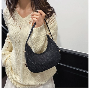 Close-up of black glitter hobo bag with sequin texture and sleek crescent shape