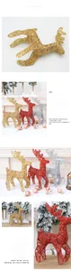 Close-up of golden, red, and silver glitter Christmas deer statues for festive tabletop decor