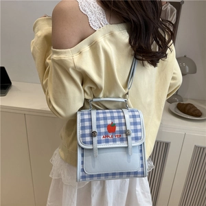 Blue and white checkered crossbody bag with red apple embroidery and leather details