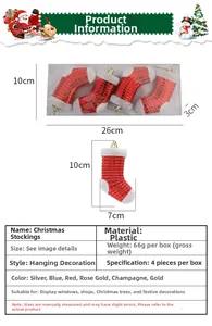 Detail view of four red plastic Christmas stocking ornaments with golden hanging strings