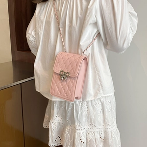 Pink quilted crossbody phone bag with silver bow buckle and leather-chain strap
