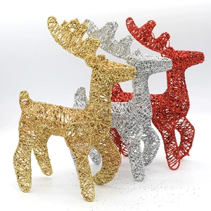 Three glittery metal Christmas deer figurines in gold, silver, and red colors