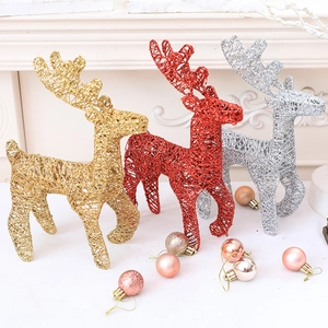 Three 25cm glittering Christmas reindeer figurines in gold, red, and silver with ornaments