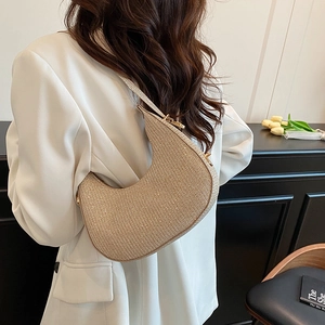 Minimalist champagne gold crescent shoulder bag with shimmery finish for summer 2025 fashion