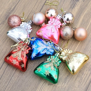 Colorful Christmas tree gift bag ornaments and glittering baubles on wood background