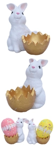 Detail of resin Easter bunny with a golden eggshell container for decorative colorful eggs