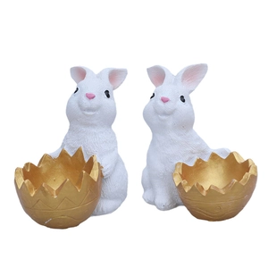 Resin Easter bunnies with golden egg shell holders for festive tabletop decoration
