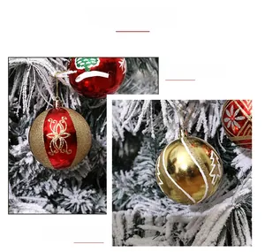 Detailed close-up of 8cm red and gold Christmas balls with snowflake glitter patterns