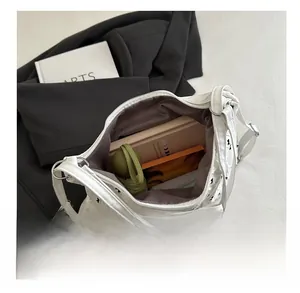 Detail showing high capacity of white butterfly print pleated bag with daily essentials