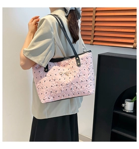 Detail showing the pink quilted tote bag with long black shoulder straps and a gold bow