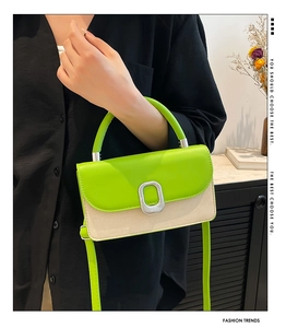 Detail of neon green leather flap and woven beige texture on chic crossbody bag