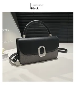 Detail shot of the two-tone grey fabric and black leather shoulder bag with silver buckle