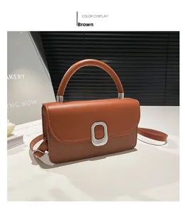Detail of brown crossbody bag featuring dual-texture leather and woven stitching design