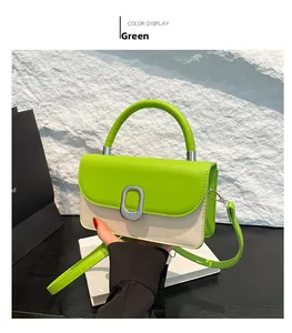 Detail of green leather and straw woven crossbody bag with metallic clasp and handle