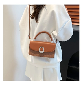 Close-up of dual-tone vintage small square bag with woven texture and silver buckle