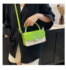 Detail of neon green leather and beige canvas crossbody bag with silver square lock