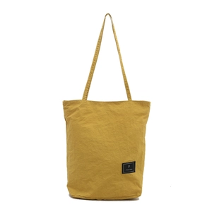 Minimalist yellow nylon crossbody bag with textured fabric and adjustable strap