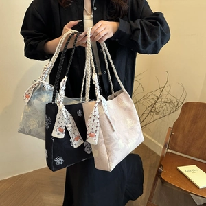 Elegant floral canvas bucket bags with braided handles in blue, black, and pink colors