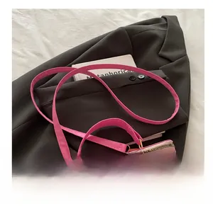 Detail of pink cherry pattern handbag with golden metal buckles and zipper closure
