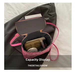 Interior view showing the large storage capacity of a pink cherry print cylinder bag
