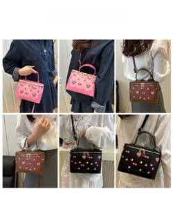 Model lifestyle shots showing black, brown, and pink cherry print vanity crossbody bags