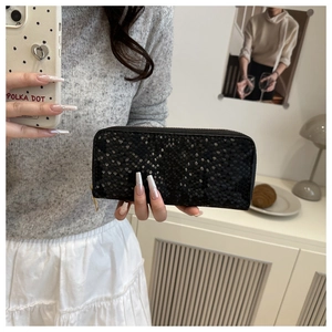 Detail of elegant black snakeskin texture wallet with premium golden metal zipper