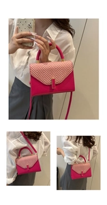 Detail of magenta fashion handbag with pink herringbone weave texture and gold hardware