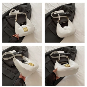 Detail of white moon hobo bag with gold geometric interlocking buckle and leather texture