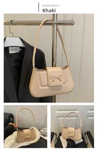 Detail shots of khaki faux leather baguette bag featuring a gold bow buckle closure
