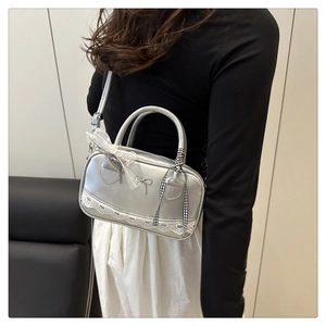Silver mirror bowling bag with lace trim and black checkered bow detail on shoulder strap
