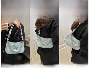 Pale blue glitter handbag with silver bow detail shown in three versatile carrying styles