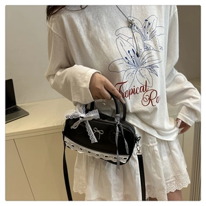Lace detail of a sweet Lolita black crossbody bag with silver bow and ribbons